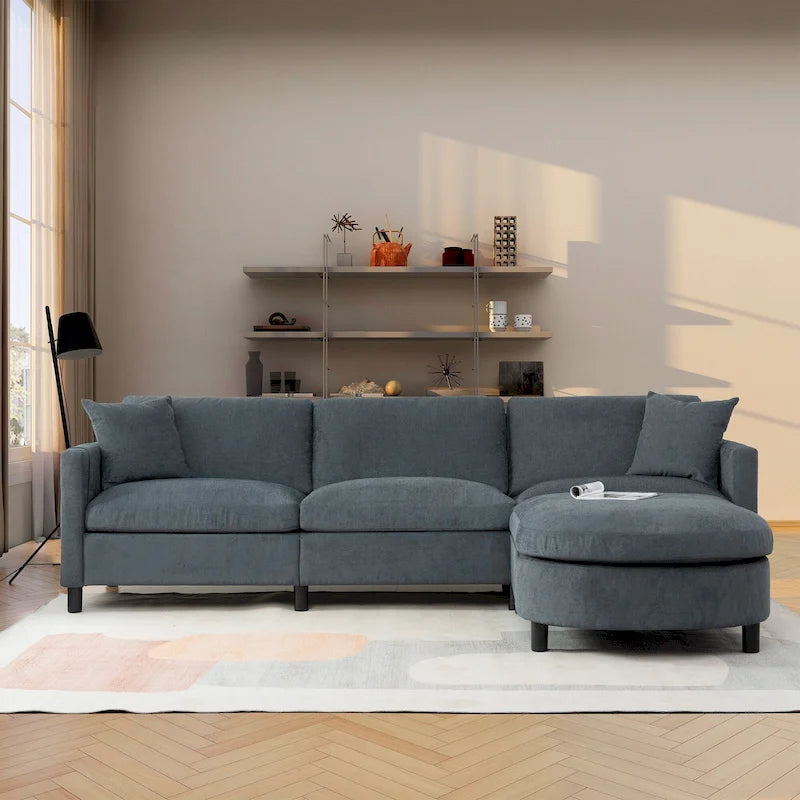 Canapé d'angle 4 places en tissu gris foncé avec pouf et accoudoir de rangement