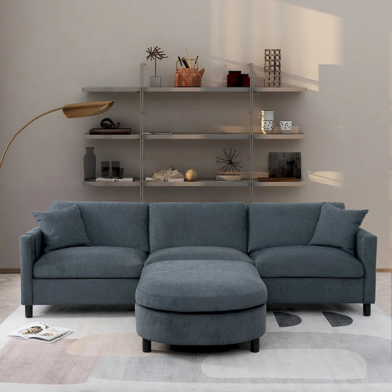 Canapé d'angle 4 places en tissu gris foncé avec pouf et accoudoir de rangement