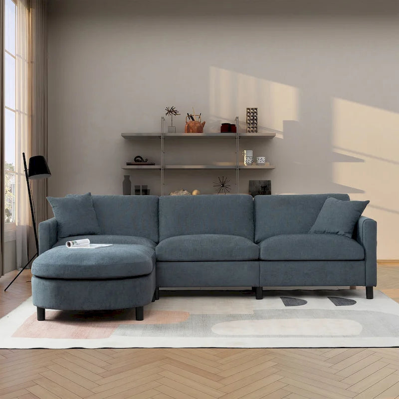 Canapé d'angle 4 places en tissu gris foncé avec pouf et accoudoir de rangement