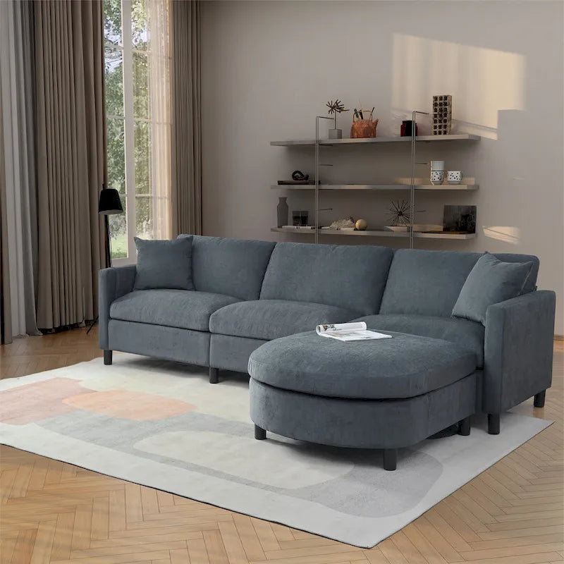 Canapé d'angle 4 places en tissu gris foncé avec pouf et accoudoir de rangement