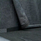 Canapé d'angle 4 places en tissu gris foncé avec pouf et accoudoir de rangement